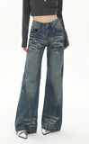 Model wearing the blue Retro Flare Distressed Denim Jeans in a gray background
