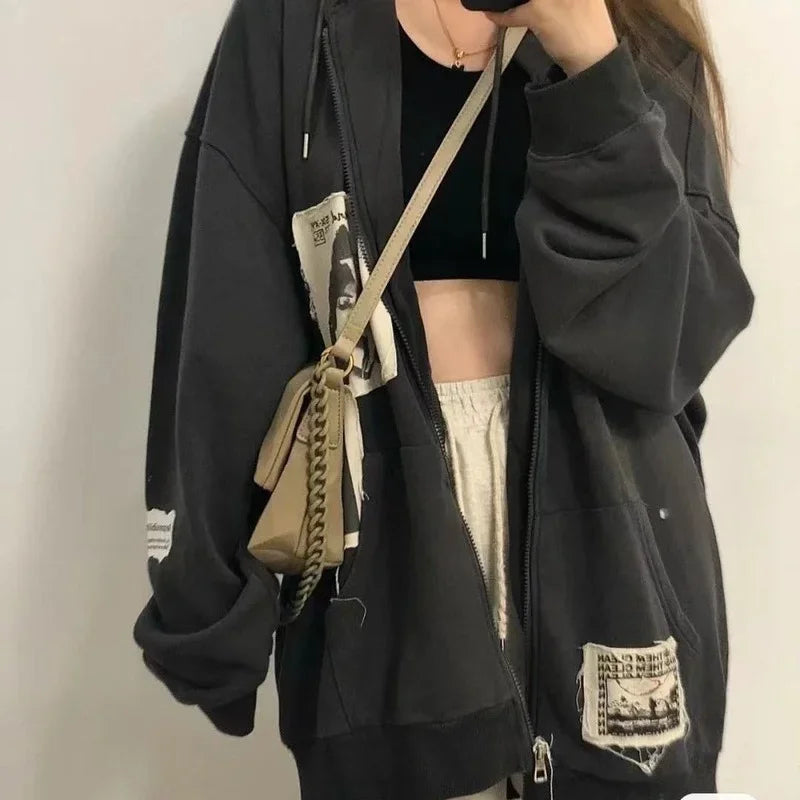 Model wearing the gray Graphic Patchwork Zip-Up Sweatshirt