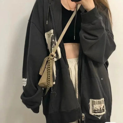 Model wearing the gray Graphic Patchwork Zip-Up Sweatshirt