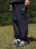 A guy in field wearing navy blue AirPods Pants