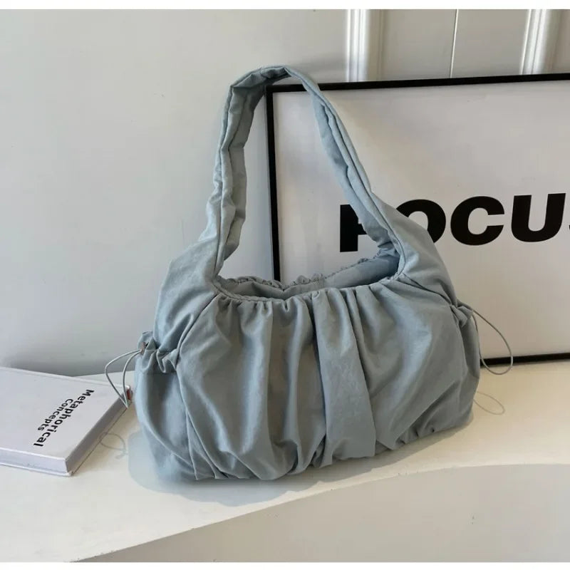 Front view of the blue Wanderlust Sling Bag  