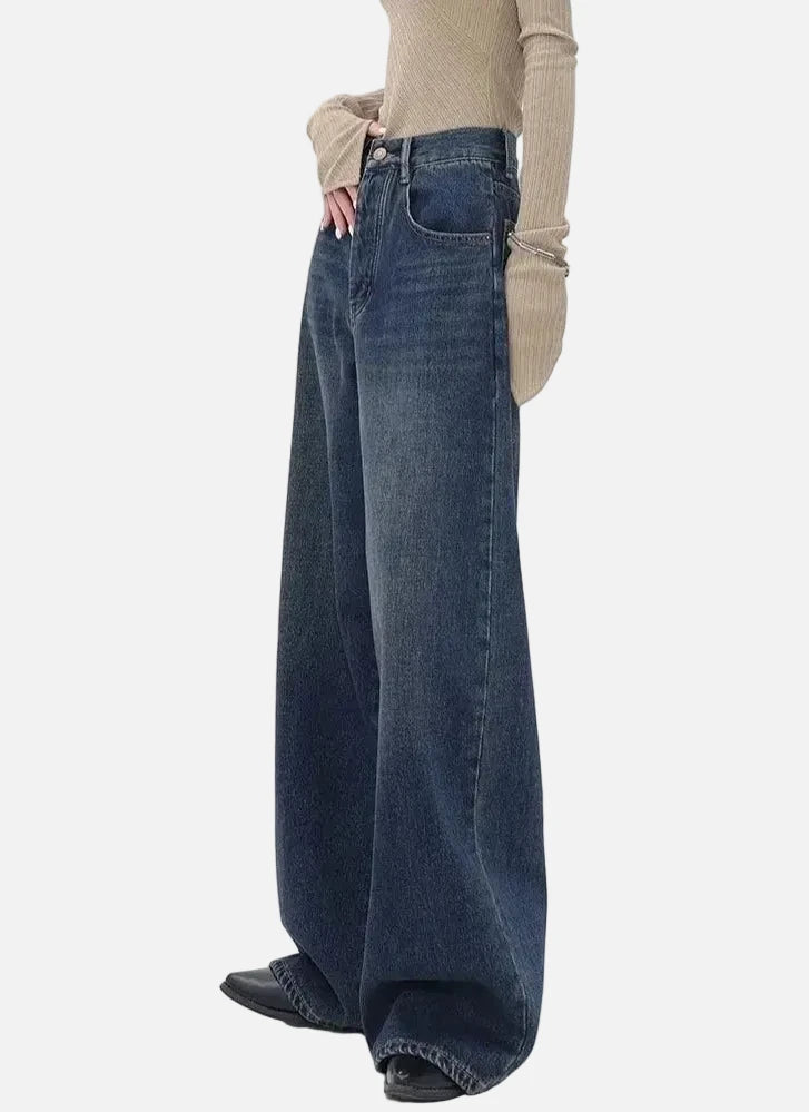 Model wearing the blue Retro Dark Washed Jeans in a gray background
