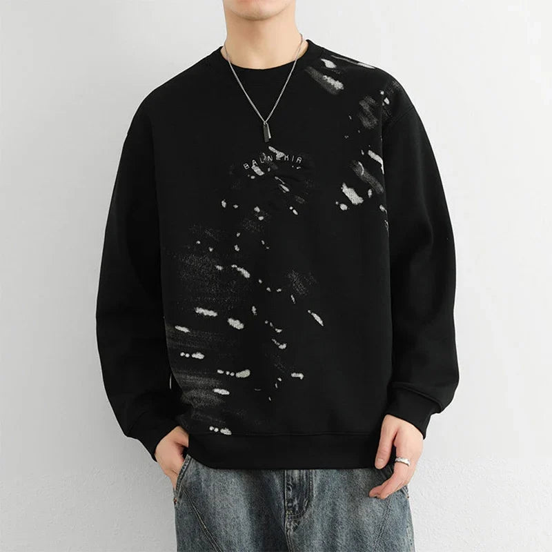 Model wearing the black Abstract Paint Splatter Sweatshirt