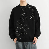 Model wearing the black Abstract Paint Splatter Sweatshirt