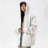 Model wearing the light gray Edgy Urban Zip-Up Hoodie in a gray background