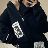 Model wearing the black Graphic Patchwork Zip-Up Sweatshirt
