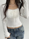 Model wearing the white Bust Bow Ruched CoquetteTop 