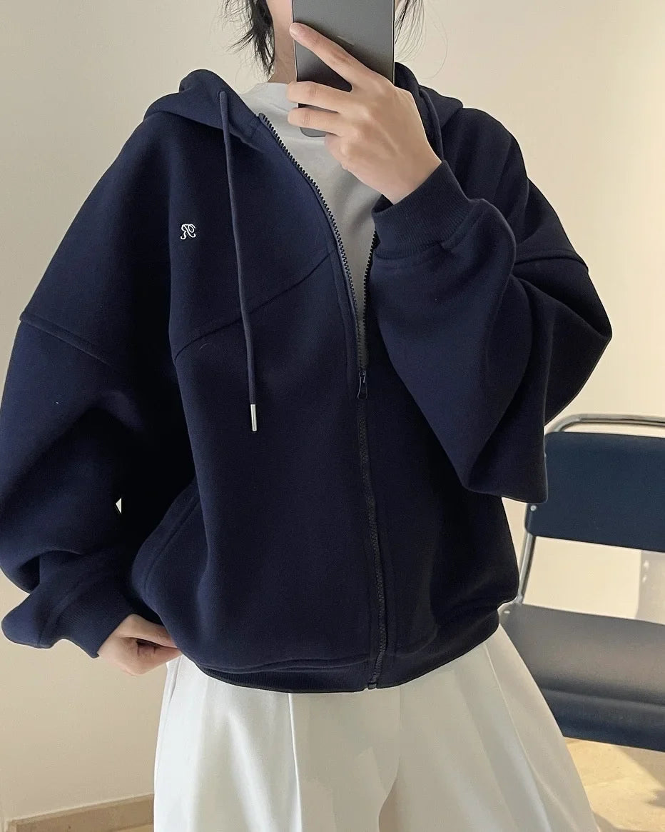 Front view of the navy blue Explorer's Dream Hoodie in a gray background 