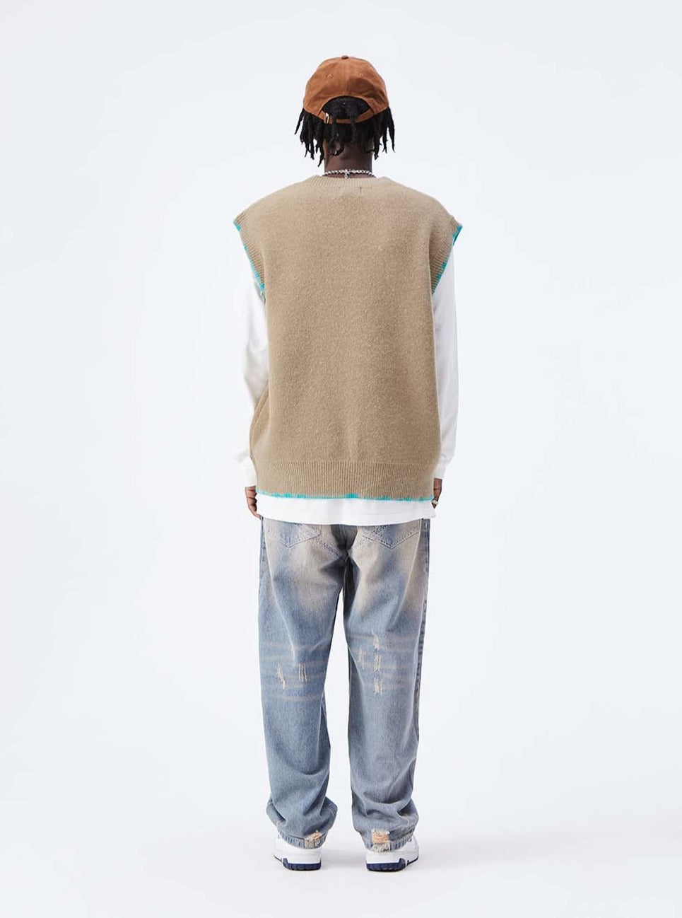 A guy wearing 72 knitted vest back view