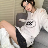 Model wearing the white interstellar Knit Reverie Sweater