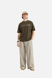 Model wearing the khaki Loose Retro Solid Pants in a gray background 