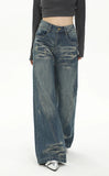 Model wearing the blue Retro Flare Distressed Denim Jeans in a gray background