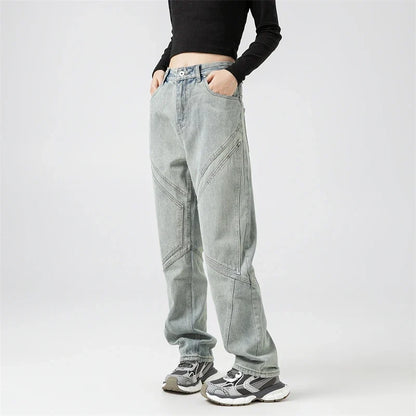 Model wearing the blue Y2k Rivet Pocket Jeans in a gray background 