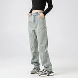 Model wearing the blue Y2k Rivet Pocket Jeans in a gray background 