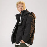 Model wearing the black Solid Hooded Collar Puffer Jacket in a gray background