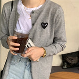 Model wearing the gray Heart Patch Button-Up Sweater