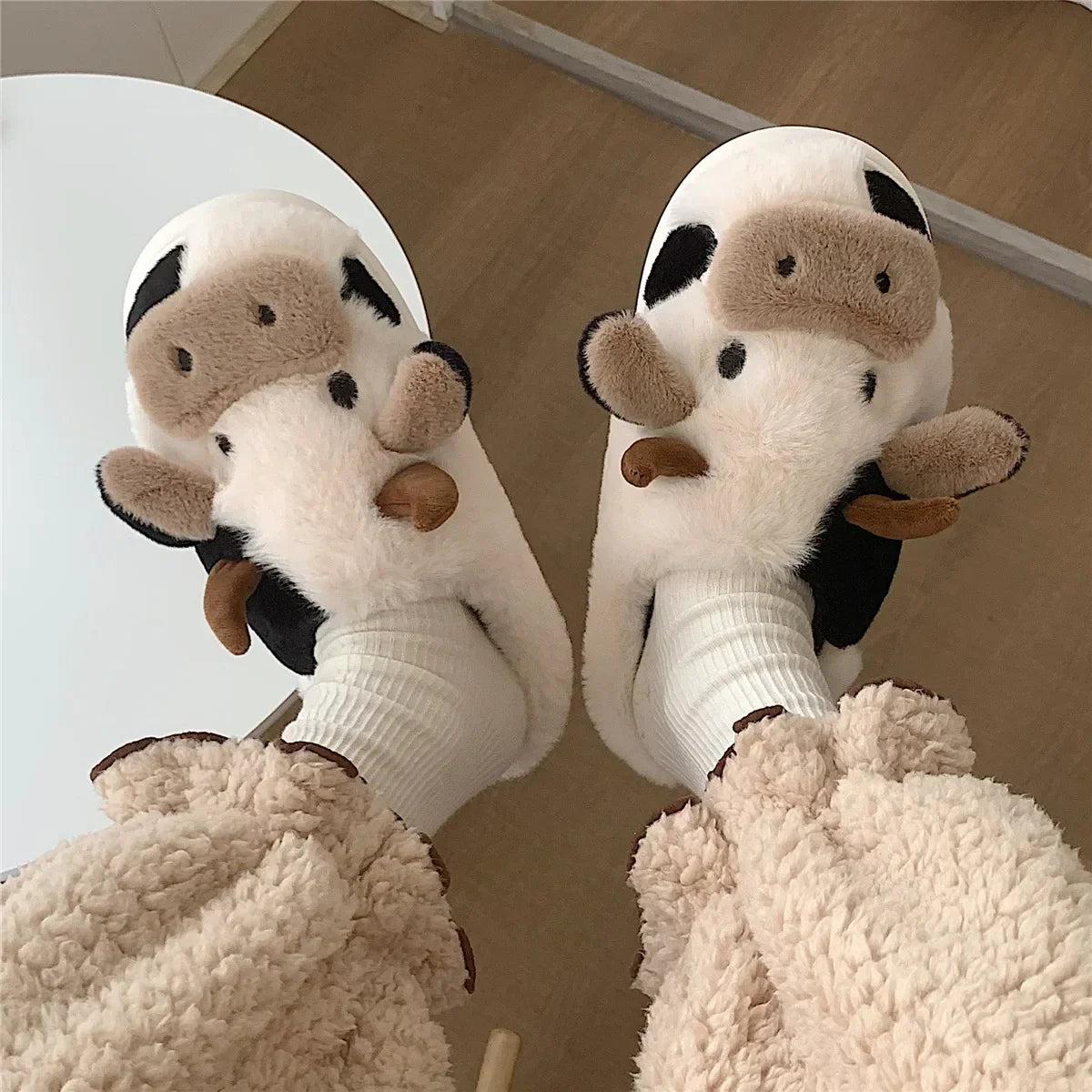 Model wearing the white Cow Slippers