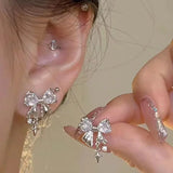 Model wearng the white Gleaming Charm Drops Earrings