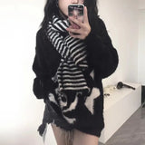 Modern wearing the black Skull Embrace Sweater