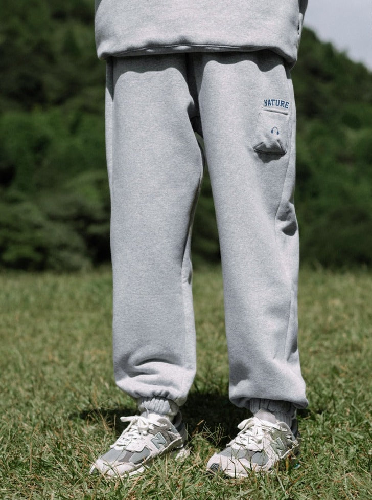 A guy wearing grey AirPods Pants