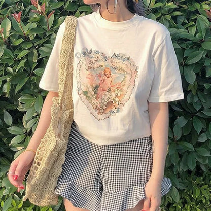 Model wearing the white Cherub Heart With Love And Devotion T-Shirt