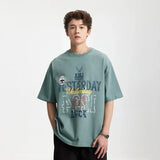 Model wearing the blue gray Style Sphere T-Shirt in a gray background