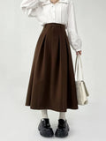 Model wearing the brown Long Pleated Skirt