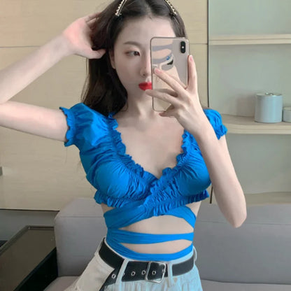 Model wearing the white Ruffled Cut-Out Wrap Top
