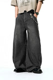 Model wearing the black Vintage Wid-Leg Denim Jeans in a gray background