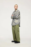 Model wearing the green Fractal Elegance Cargo Pants