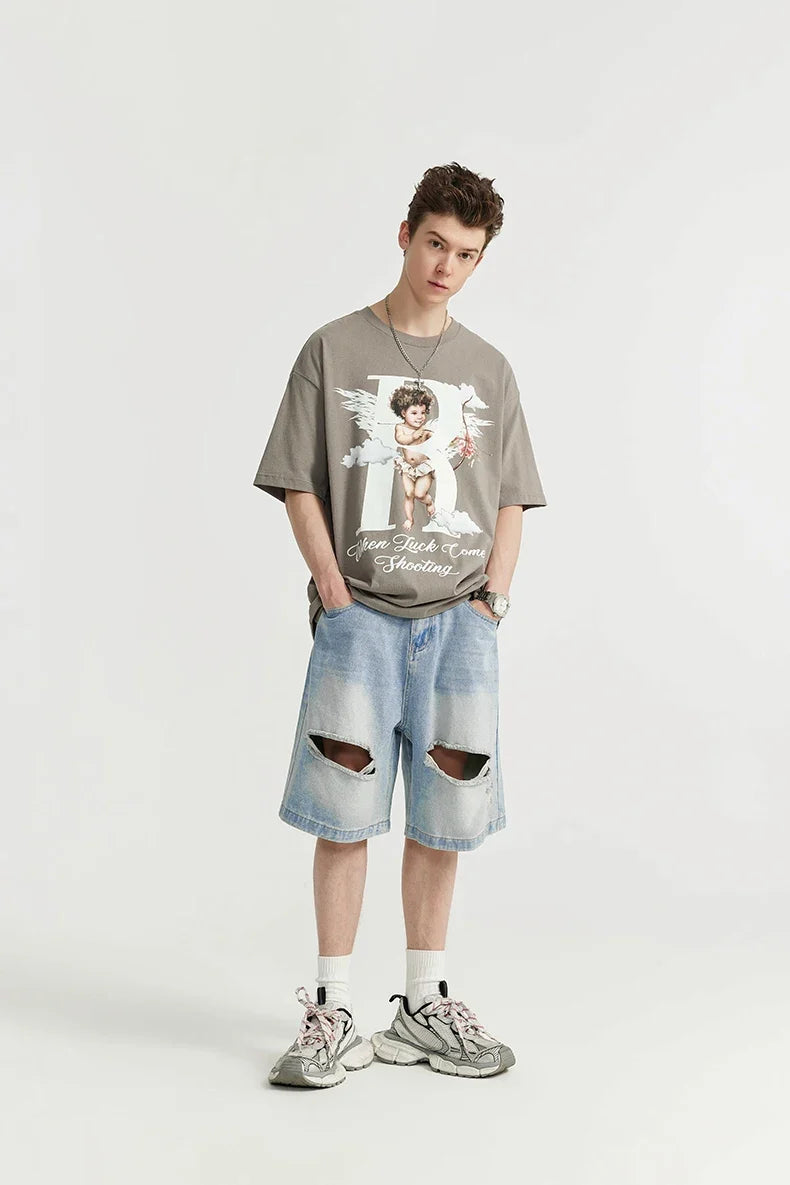 A model wearing the light blue Vintage Ripped Holes Denim Jorts in a gray background 