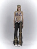Model wearing the blue Distressed Patchwork Cross Jeans