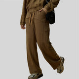 Model wearing the Coffee Y2k Vintage Baggy Jeans in a gray background 