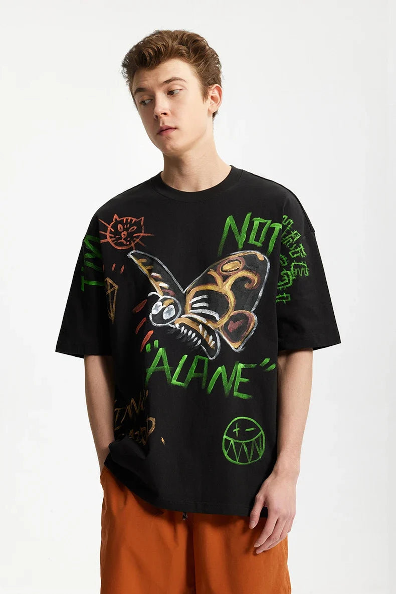 Model wearing the black Vibrant Expressions Graphic T-Shirt