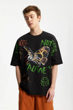 Model wearing the black Vibrant Expressions Graphic T-Shirt