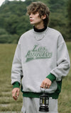 A guy wearing grey Los Angeles Sweatshirt