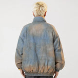 A model wearing the Vintage Washed Dye Denim Jacket while showing  the back view of the jacket