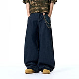 Model wearing the dark blue Vintage Wid-Leg Denim Jeans in a gray background