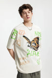 Model wearing the beige Vibrant Expressions Graphic T-Shirt