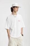 Model wearing the white Dream Forge Apparel T-Shirt in a gray background
