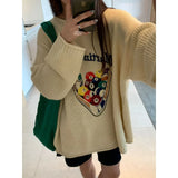Model earng the apricot Cue Break Graphic Sweater