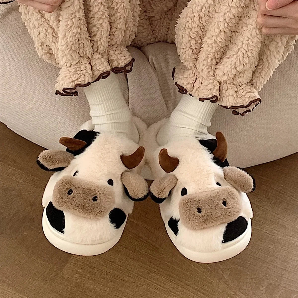 Model wearing the white Cow Slippers