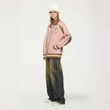 Model wearing the pink Oversized Star Emblem Sweater