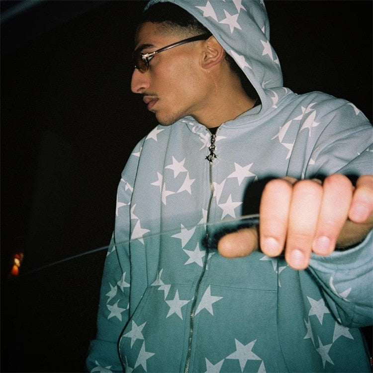 A model standing in front of a car window while wearing the sky blue Vintage Star Graphic Hoodies