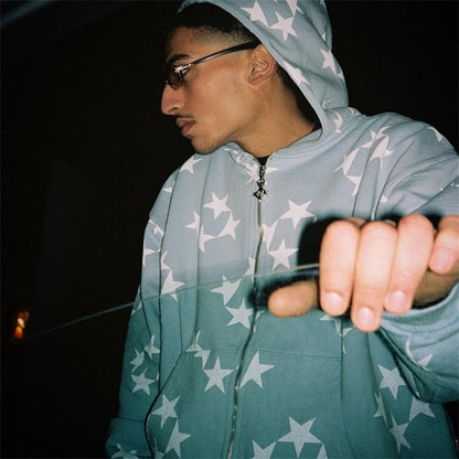 A model standing in front of a car window while wearing the sky blue Vintage Star Graphic Hoodies