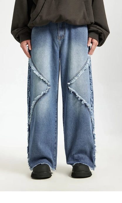 Model wearing the blue Frayed Flow Jeans in a gray background
