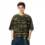 Model wearing the khaki Urban Explorer Oversized T-Shirt in a gray background