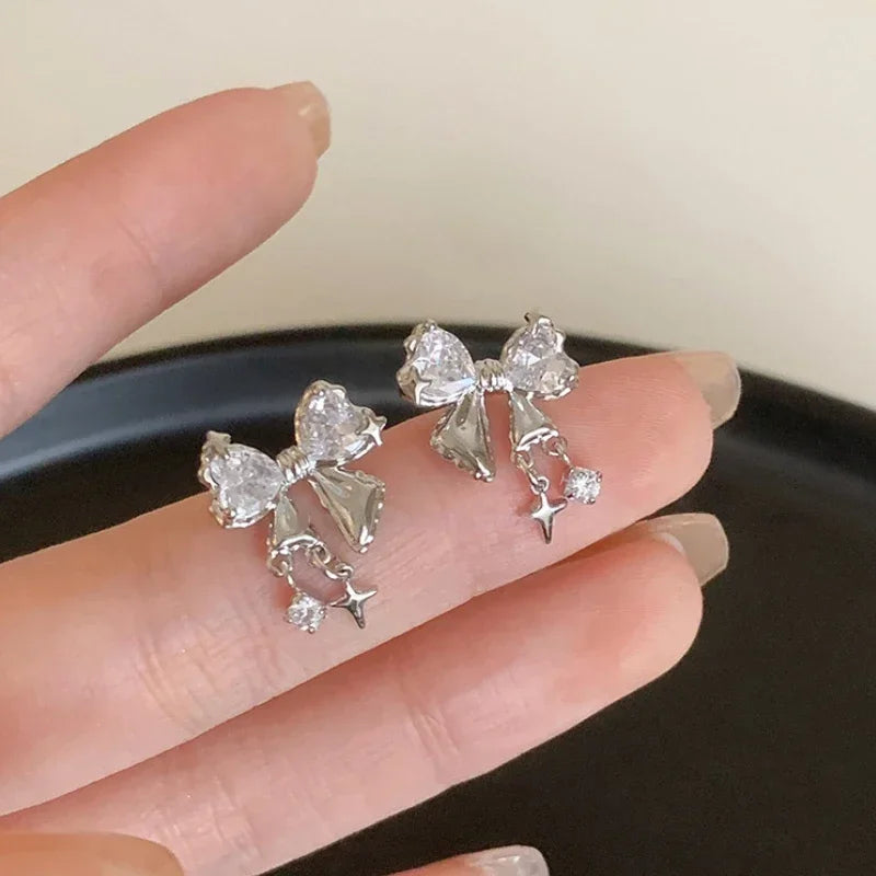 Front view of the white Gleaming Charm Drops Earrings