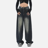 Model wearing the deep blue Vintage Washed Denim Jeans in a gray background
