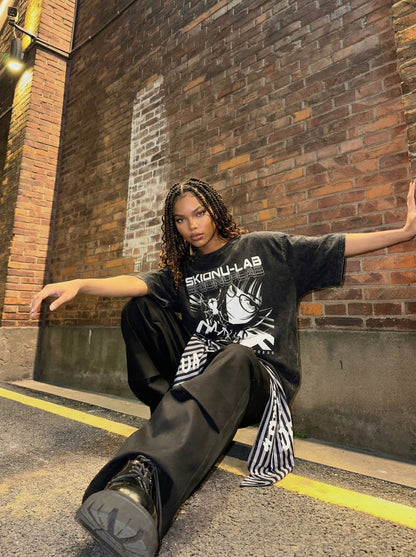 Washed black oversized short-sleeve t-shirt with anime graphic — model photo
